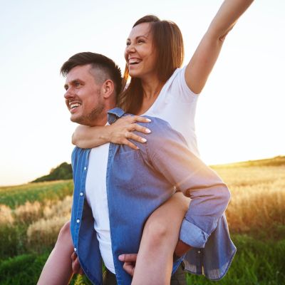 young-man-carrying-girlfriend-on-his-shoulders-JUFAFGM 2